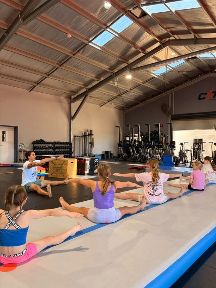 Students stretching with coach