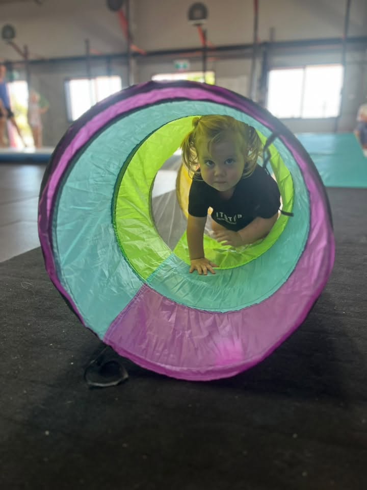 Toddler in play tunnel